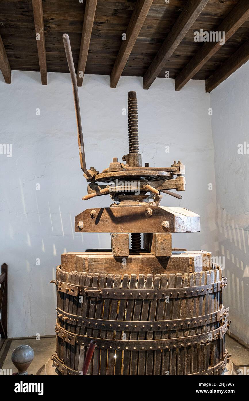 grape press in family owned El Grifo wine museum in old wine cellar