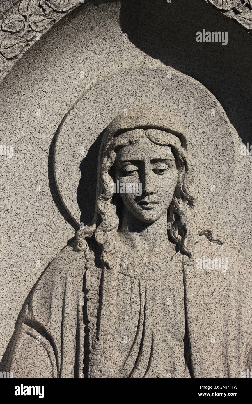 A vintage natural granite stone statue of the Virgin Mary holding out
