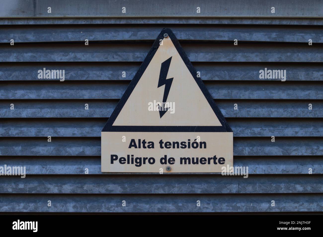 Sign on a door warning that there are high-voltage connections in that