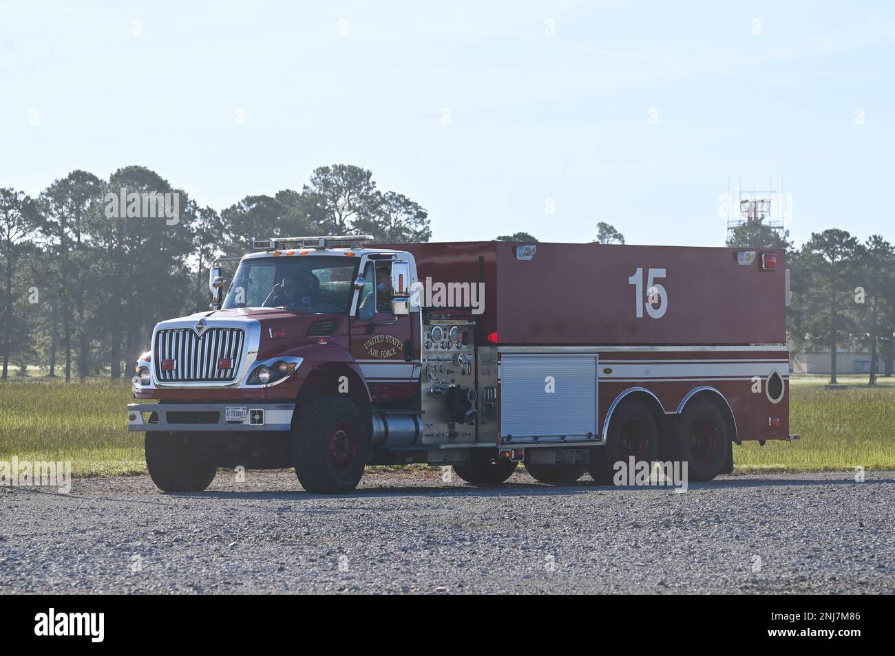 Firefighters drive a fire truck onto the live fire training site Aug. 5