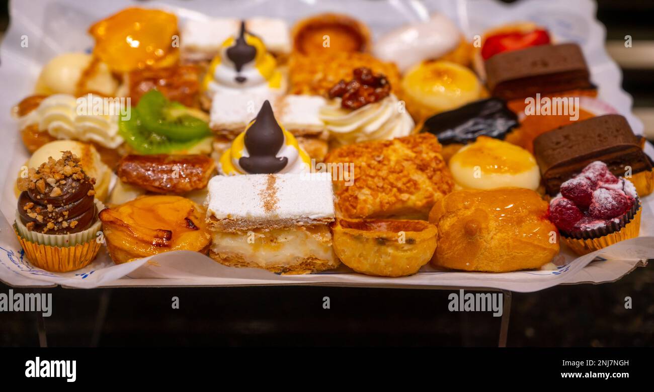 Delicious fresh baked colorful decorated cakes, tarts with cream and ...