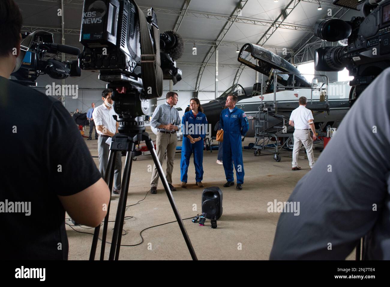 NASA representatives and pilots prepare for an interview with local news agencies during a NASA media event at Osan Air Base, Republic of Korea, Aug. 5, 2022. Media agencies were able to tour NASA’s WB-57 aircraft and the Gulfstream-V N677F from the National Science Foundation’s National Center for Atmospheric Research. These two aircraft will be conducting scientific research flights as part of the Asian Summer Monsoon Chemical and Climate Project which will investigate the impact of Asian gas and aerosol emissions on global chemistry and climate. Stock Photo