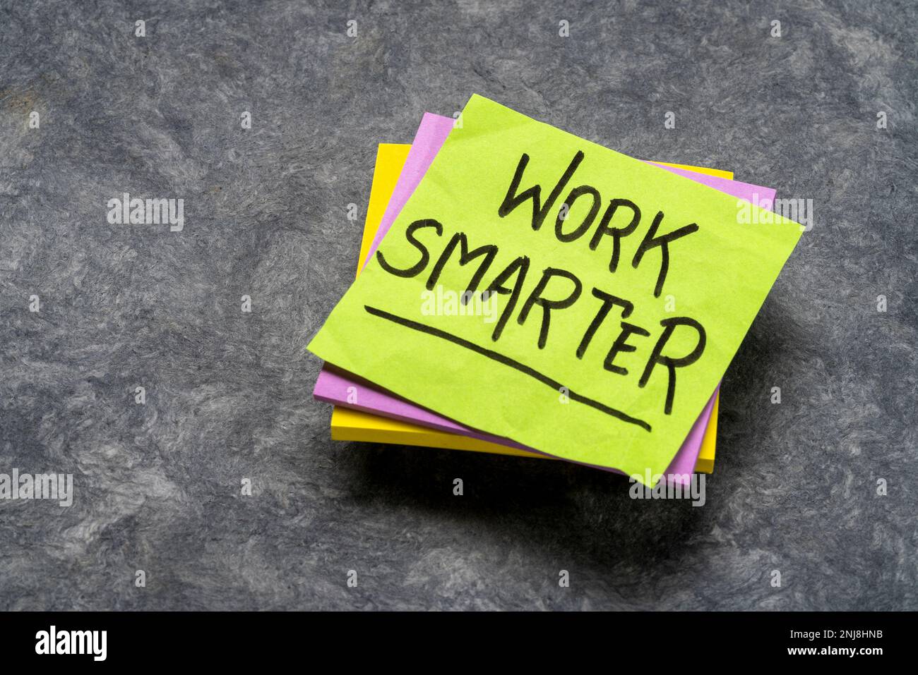 work smarter inspirational advice or reminder - handwriting on a sticky note Stock Photo