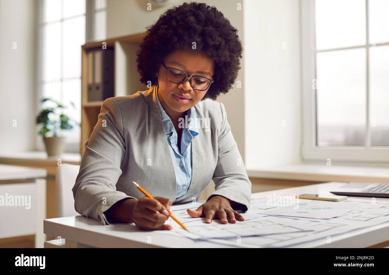 Attractive darkskinned girl, architectural engineer or designer in