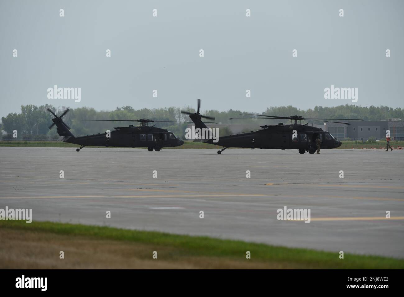 U.S. Army National Guard UH-60 Blackhawks park on the flight line at the 185th Air Refueling Wing at Sioux City, Iowa, August 6, 2022. The Blackhawks transported distinguished guests, including Maj. Gen. Benjamin J. Correll, Adjutant General of the Iowa National Guard, of the Iowa Army and Air National Guard to the 185th ARW for the unit’s Change of Command ceremony. Stock Photo