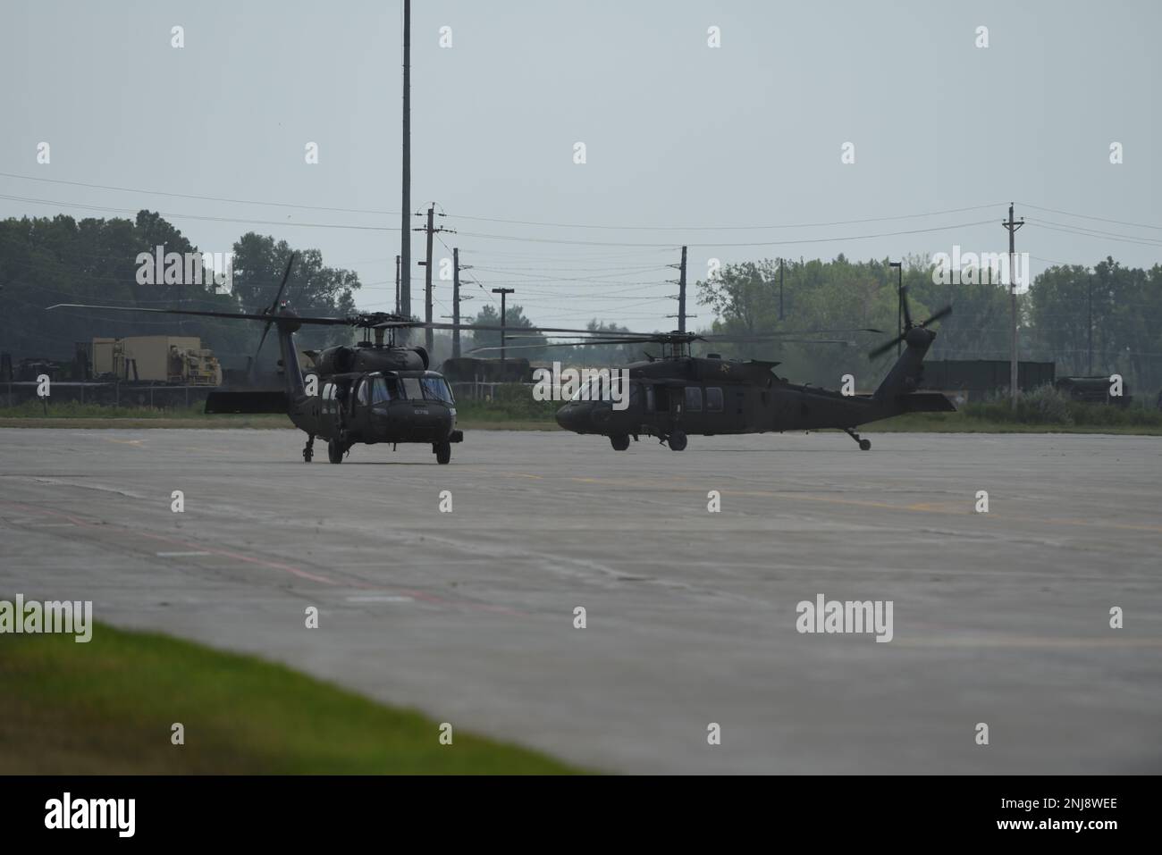 U.S. Army National Guard UH-60 Blackhawks taxi down the flight line at the 185th Air Refueling Wing at Sioux City, Iowa, August 6, 2022. The Blackhawks transported members of the Iowa Army and Air National Guard to the 185th ARW for the unit’s Change of Command ceremony. Stock Photo