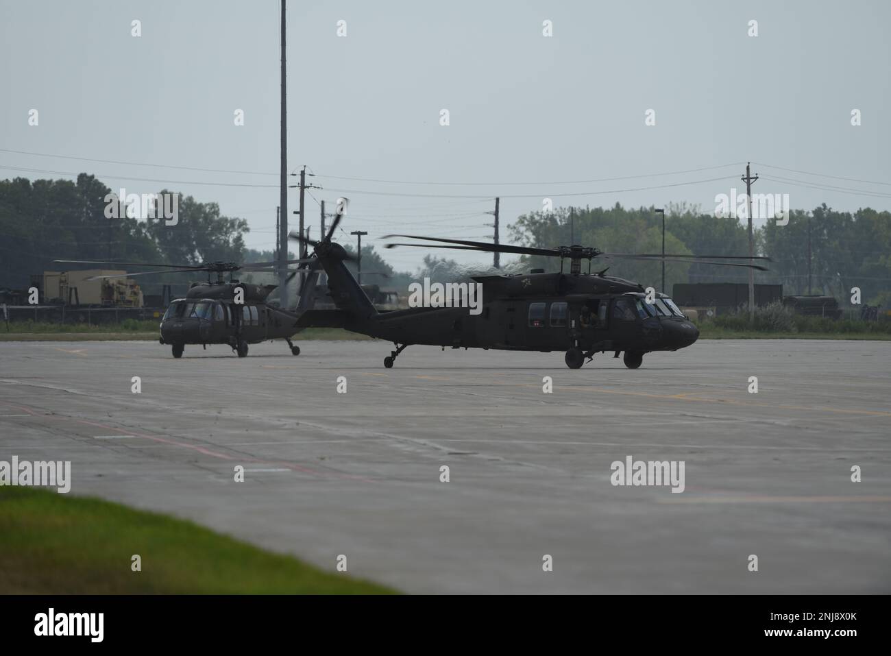 U.S. Army National Guard UH-60 Blackhawks taxi down the flight line at the 185th Air Refueling Wing at Sioux City, Iowa, August 6, 2022. The Blackhawks transported distinguished guests, including Maj. Gen. Benjamin J. Correll, Adjutant General of the Iowa National Guard, of the Iowa Army and Air National Guard to the 185th ARW for the unit’s Change of Command ceremony. Stock Photo