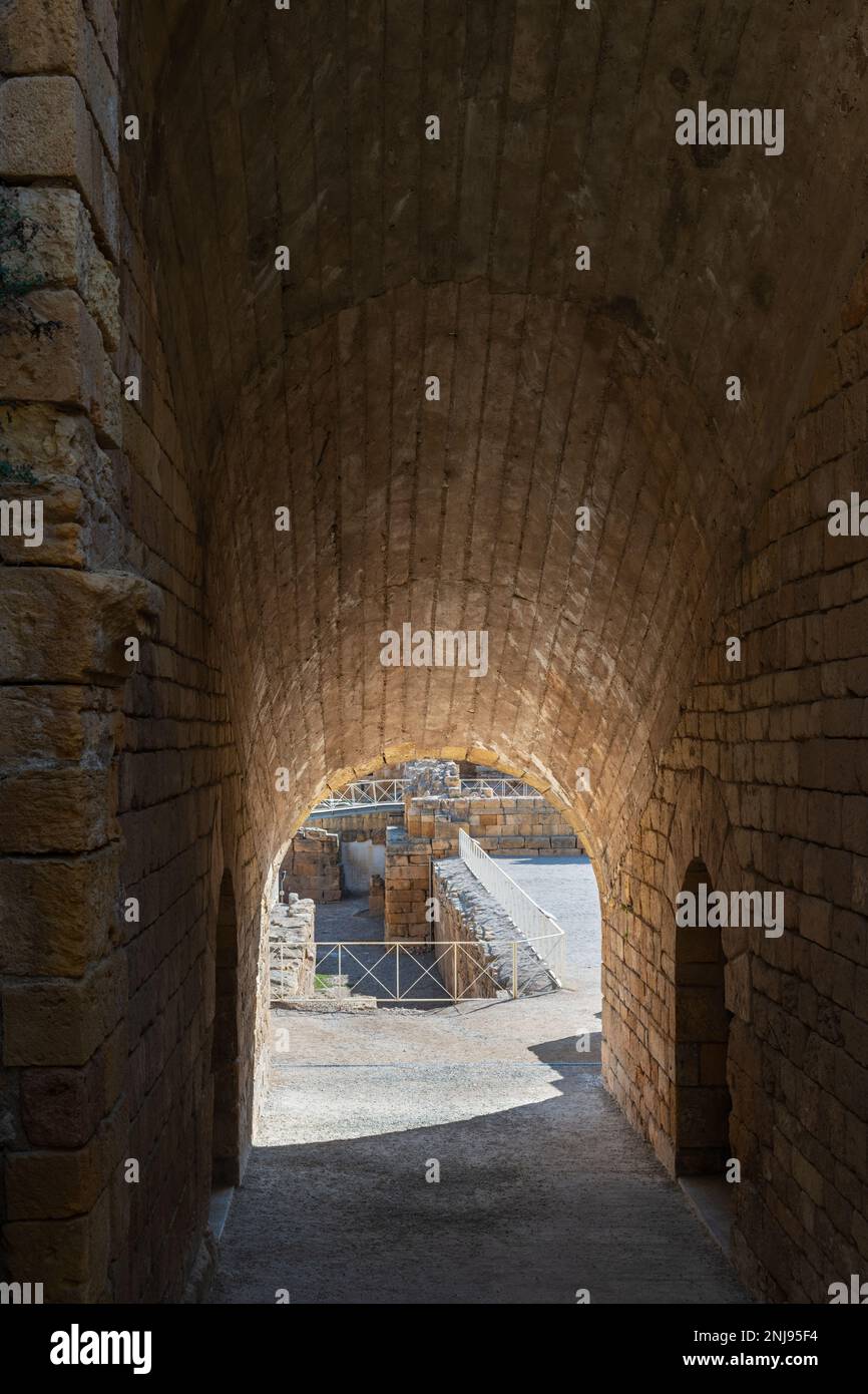 Tunnel-view of the ruins of the Roman amphitheater in Tarragona, built in the 2nd century AD, with the Mediterranean Sea in the background. Stock Photo