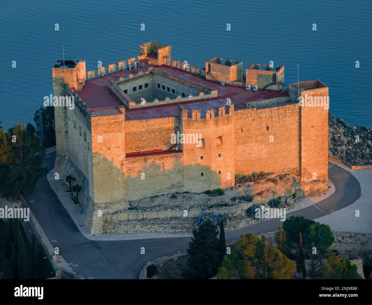 Aerial view of the castle of Mequinenza at the confluence of the Segre and Ebro rivers in a winter sunset (Bajo Cinca, Zaragoza, Aragon, Spain) Stock Photo