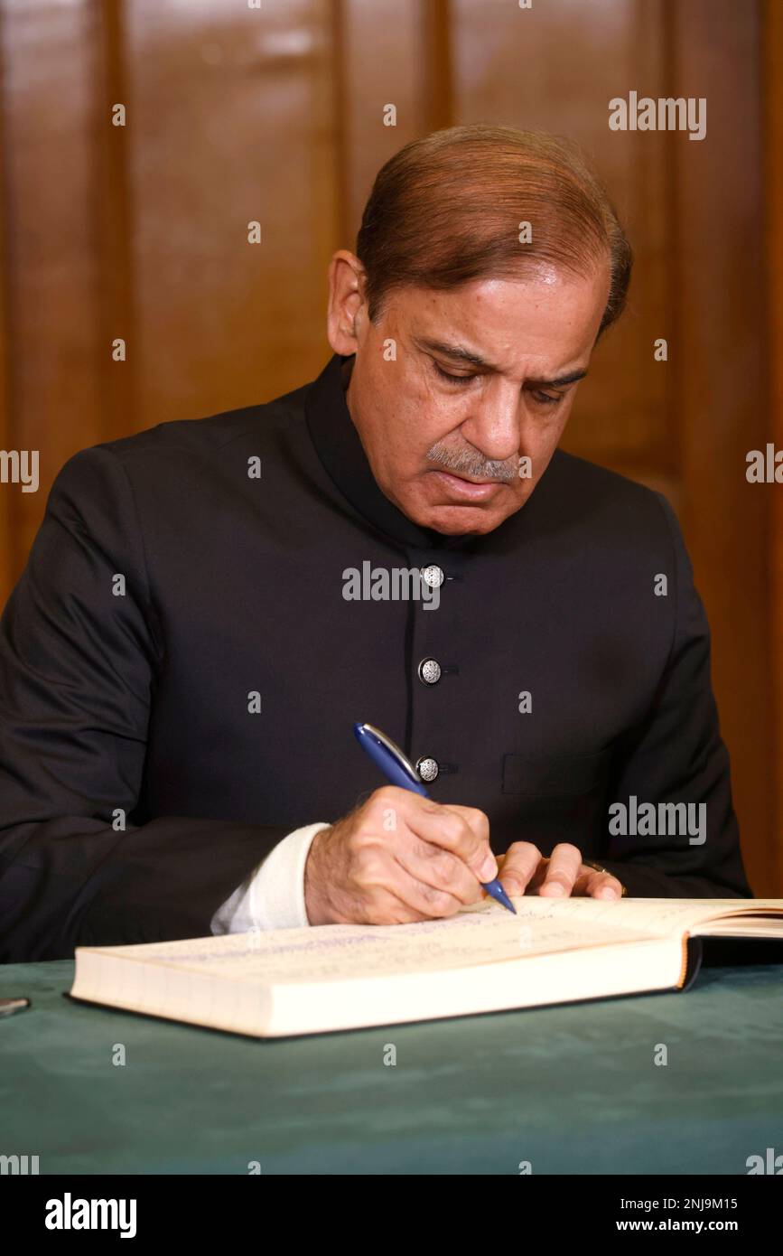 Prime Minister of Pakistan Shehbaz Sharif signs a book of condolence at