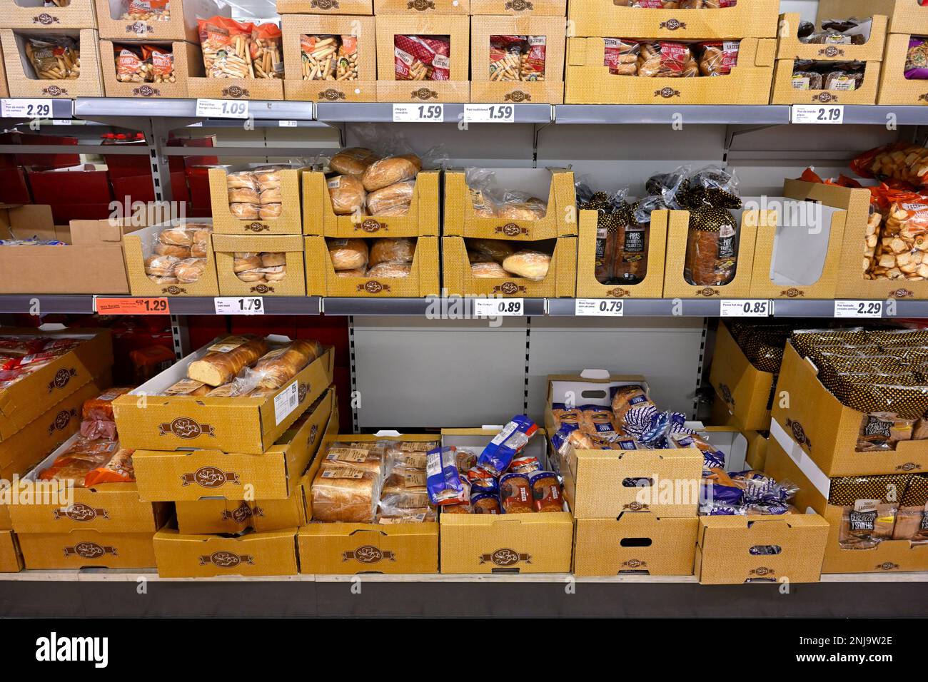 Supermarket shelves with backed goods wrapped in packing for hygiene Stock Photo