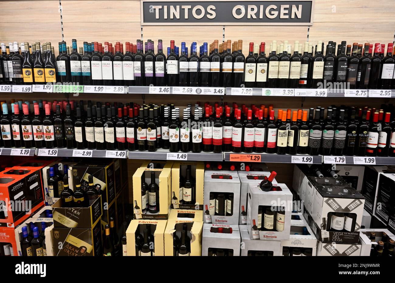 Inside supermarket with selves full of variety of red wines Stock Photo