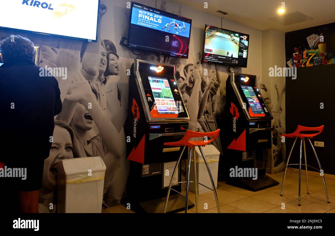 Slot machines in gambling establishment with sports showing on TVs, Sala de juego Las Vegas, Gran Canaria Stock Photo