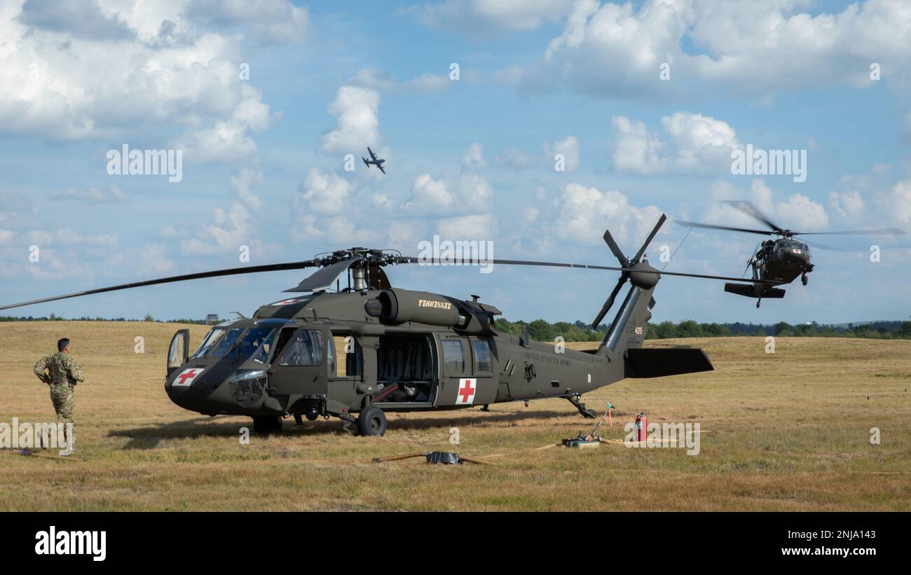 A US Army soldier assigned to the 1-230th Assault Helicopter Battalion, Tennessee Army National Guard, runs to his UH-60 Blackhawk helicopter at the beginning of Pre-accident Plan Rehearsal for Northern Strike 22 at Reaper Forward Arming and Refueling Point (FARP) on Grayling Army Airfield, Grayling, Mich., Aug. 6, 2022. Northern Strike is designed to challenge 7,400 service members with multiple forms of training that advance interoperability across multicomponent, multinational and interagency partners. Stock Photo