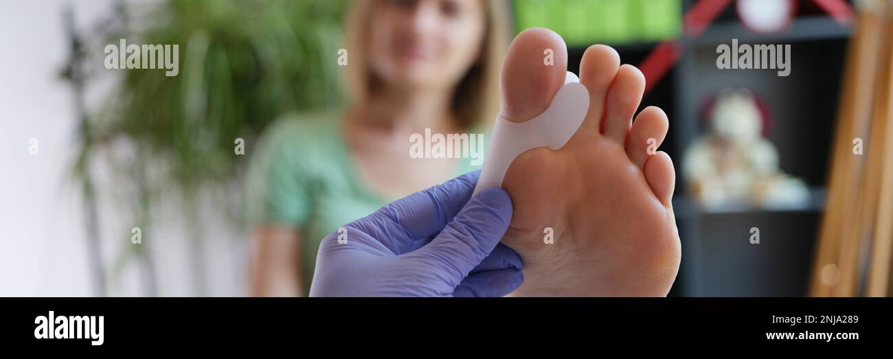 Doctor holds brace for hallux valgus closeup Stock Photo