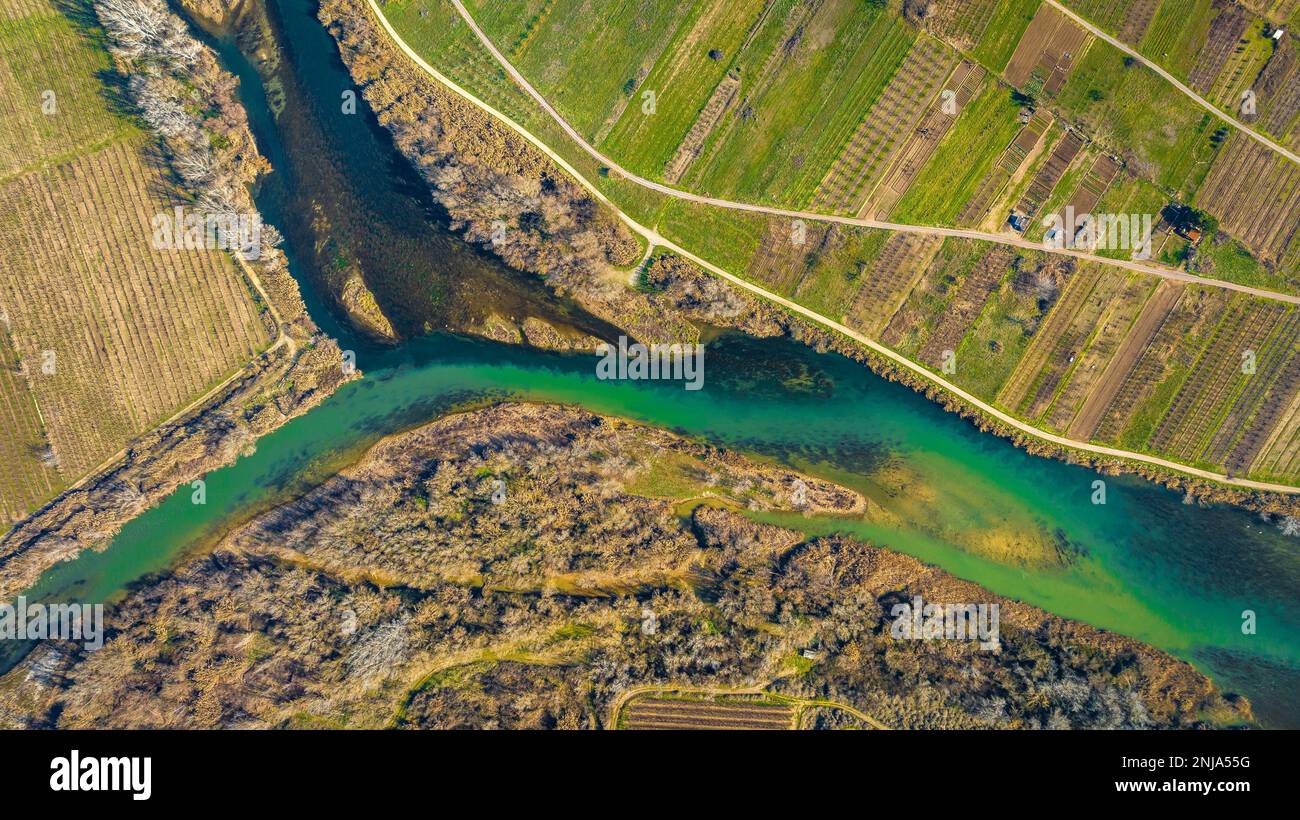 Confluence of the Segre and Cinca rivers, where you can see the different contribution of sediments from each river (Segrià, Lleida, Catalonia, Spain) Stock Photo