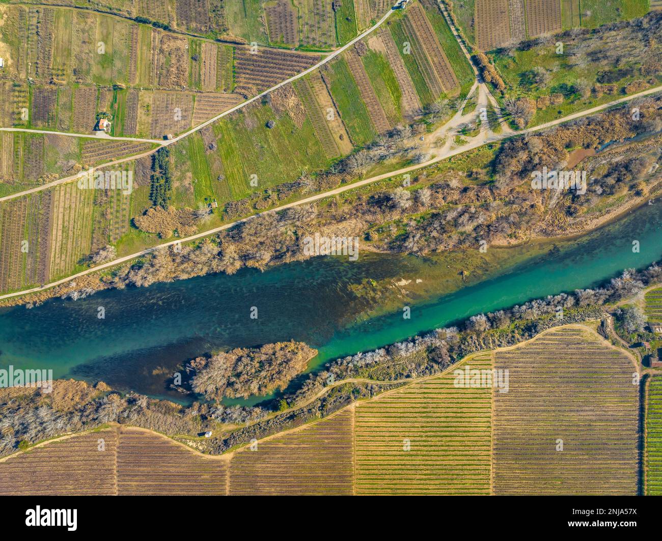 Confluence of the Segre and Cinca rivers, where you can see the different contribution of sediments from each river (Segrià, Lleida, Catalonia, Spain) Stock Photo