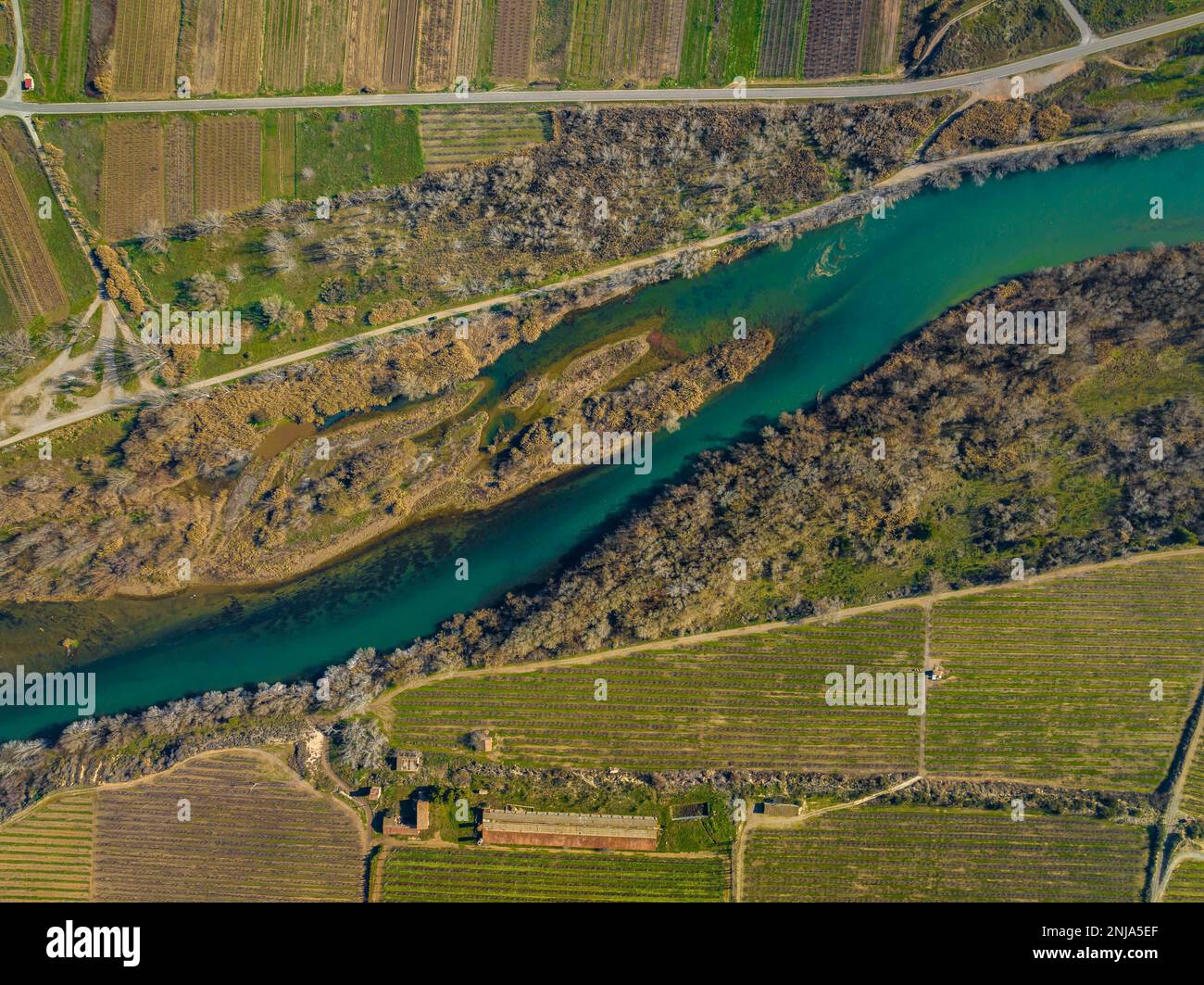 Confluence of the Segre and Cinca rivers, where you can see the different contribution of sediments from each river (Segrià, Lleida, Catalonia, Spain) Stock Photo
