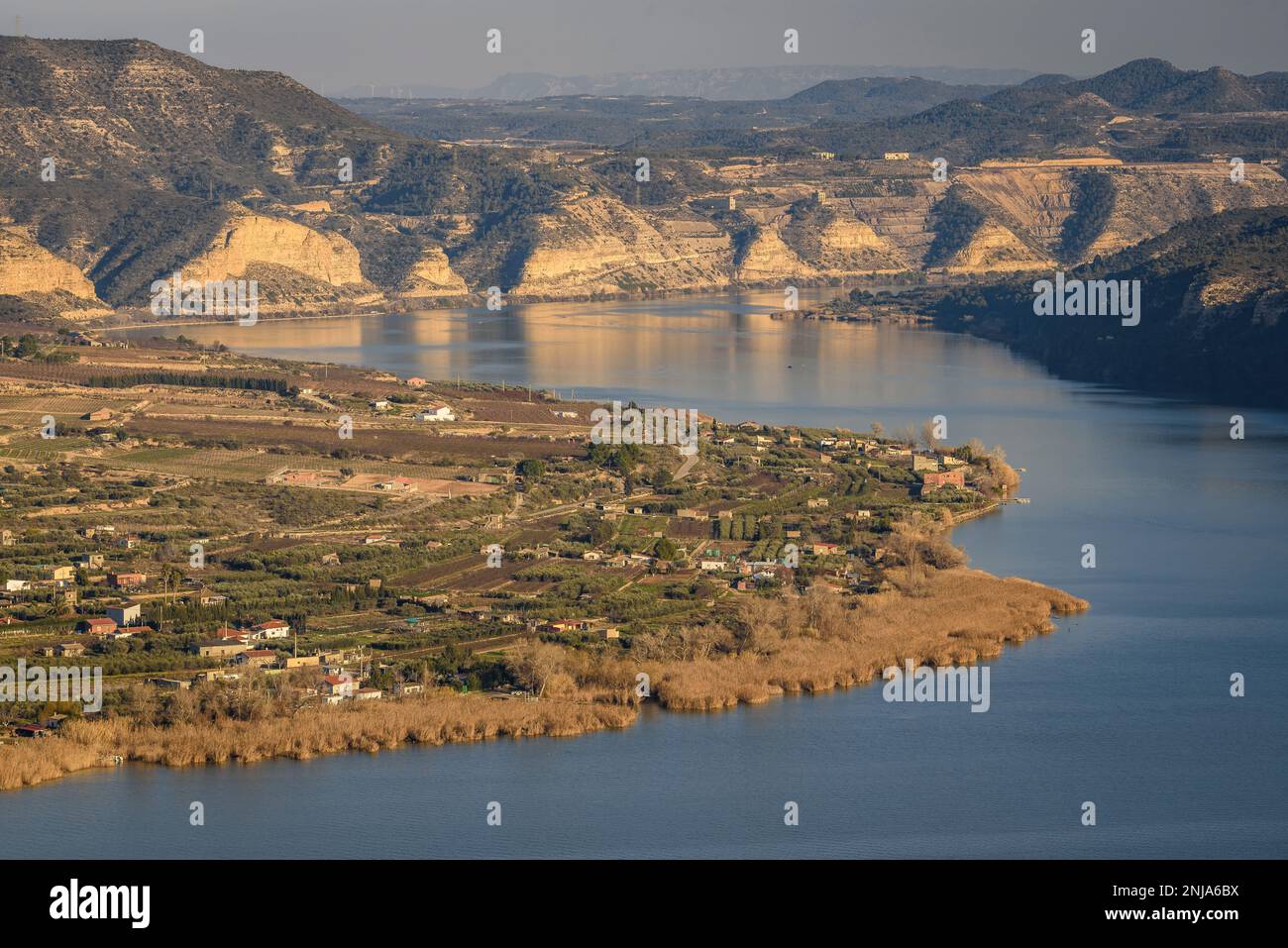 Confluence of the Segre and Ebro rivers at their junction in Mequinenza and the tail of the Riba-roja reservoir at sunset, Bajo Cinca, Zaragoza, Spain Stock Photo