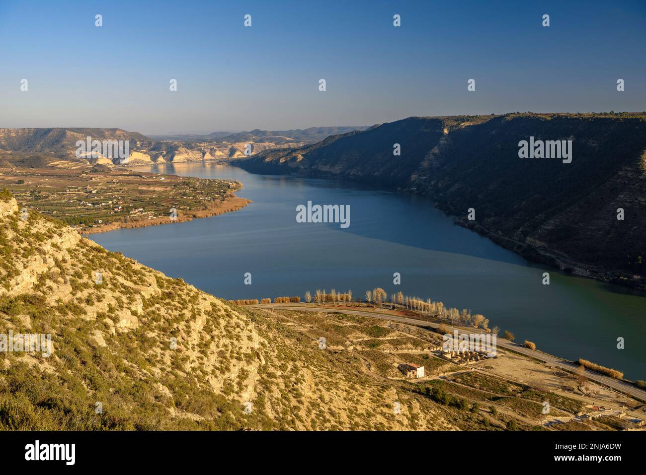 Confluence of the Segre and Ebro rivers at their junction in Mequinenza and the tail of the Riba-roja reservoir at sunset, Bajo Cinca, Zaragoza, Spain Stock Photo