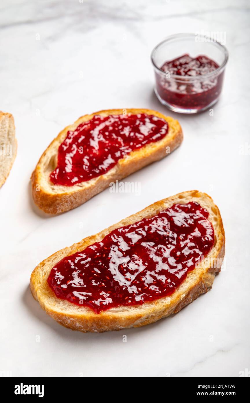 Raspberry jam on toast Stock Photo Alamy