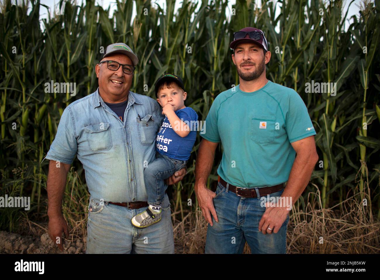 Joe Bernal, left, holding his grandson, Trevor, poses for a photo with