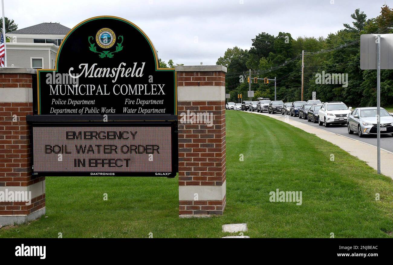 Mansfield, Mass. residents line up in front of the Department of Public