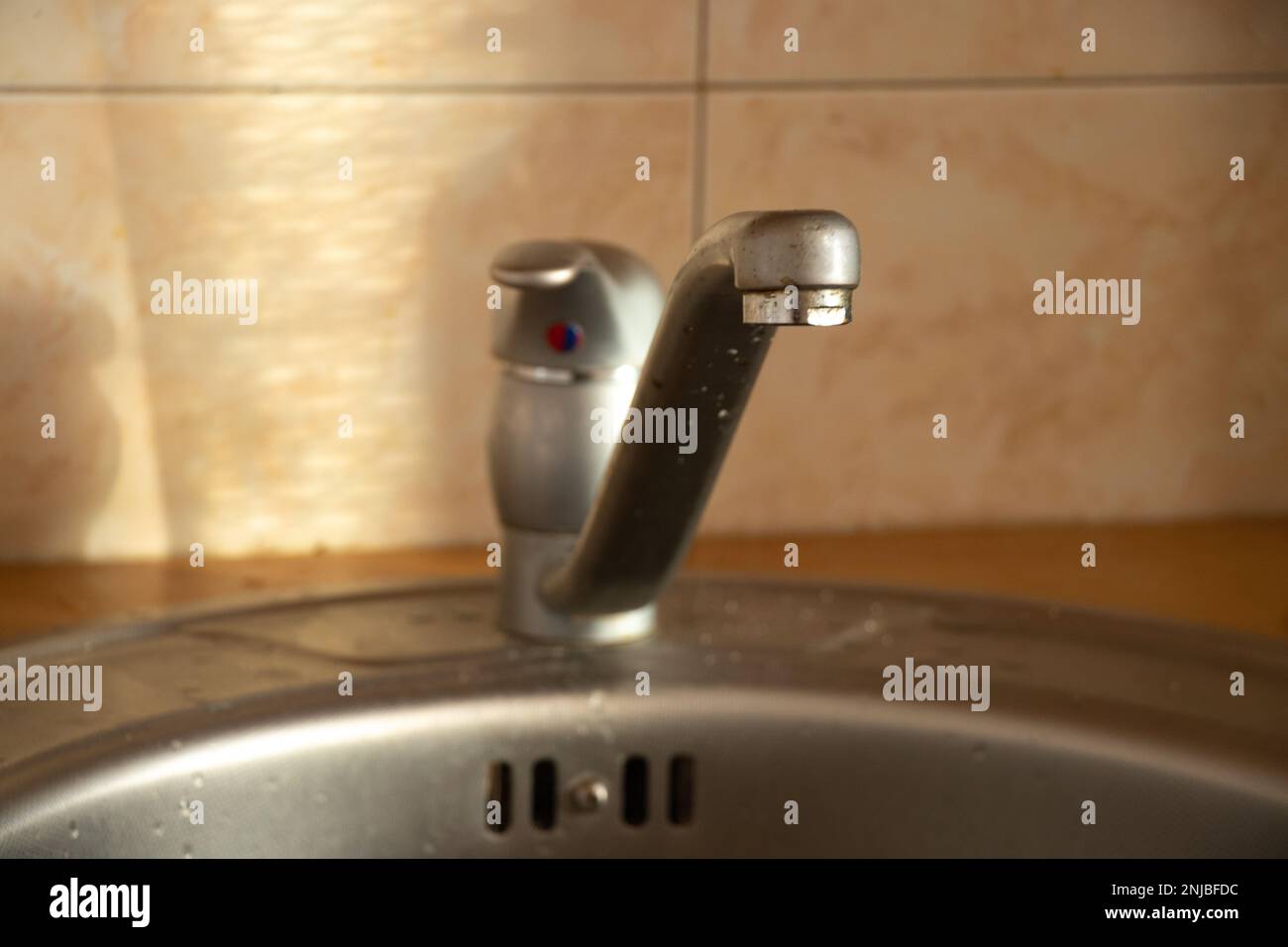cold and hot water tap in the kitchen sink Stock Photo Alamy