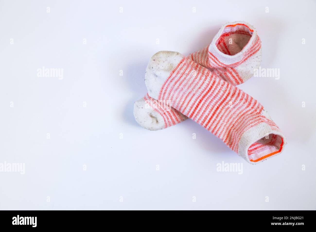 dirty white striped women's socks on a white background Stock Photo