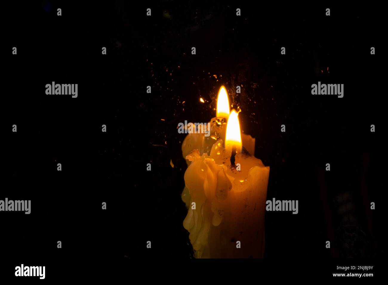 the flame of a church candle in a dark room Stock Photo Alamy