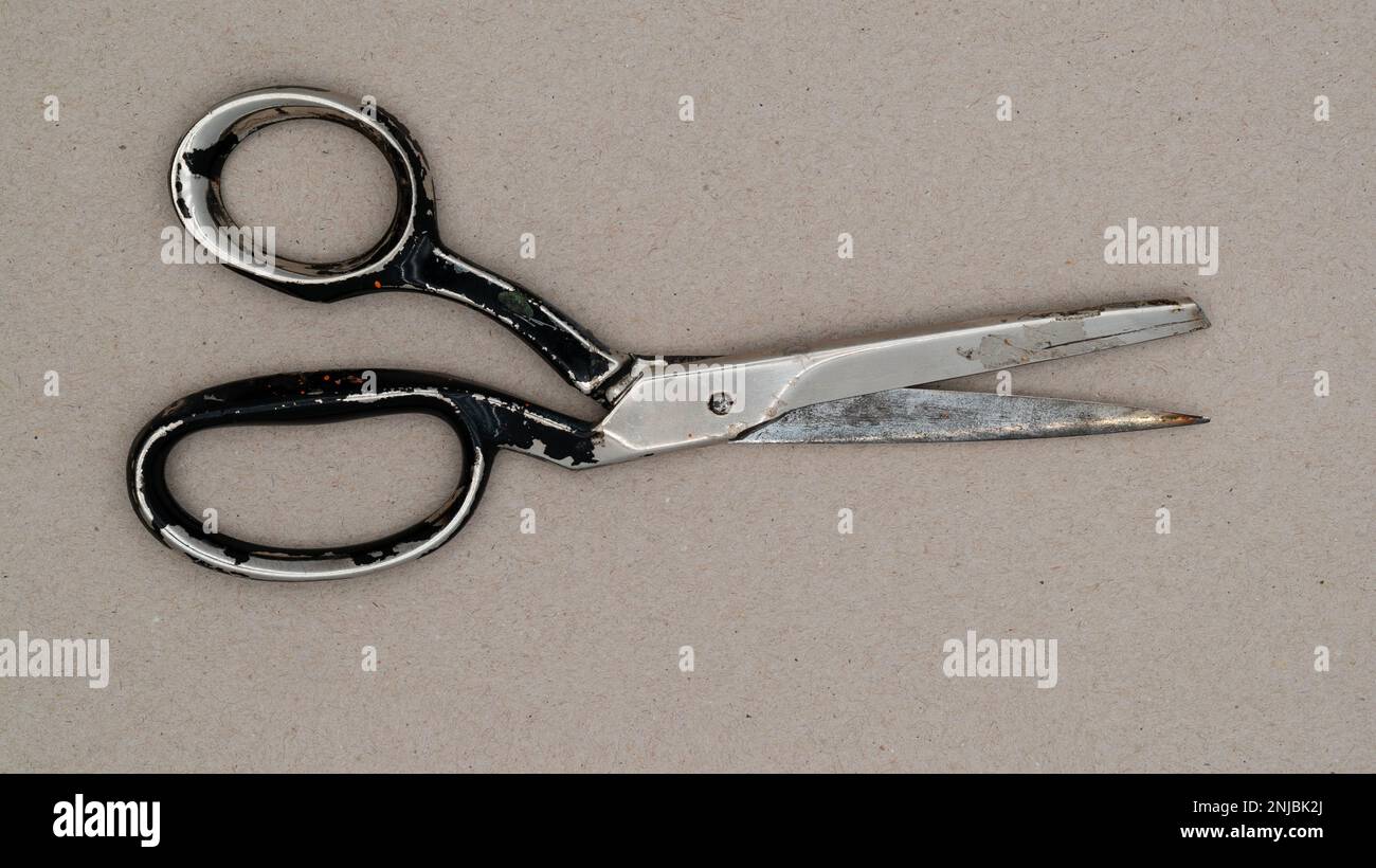 Used old scissors. Top of view of an old scissor. Stock Photo