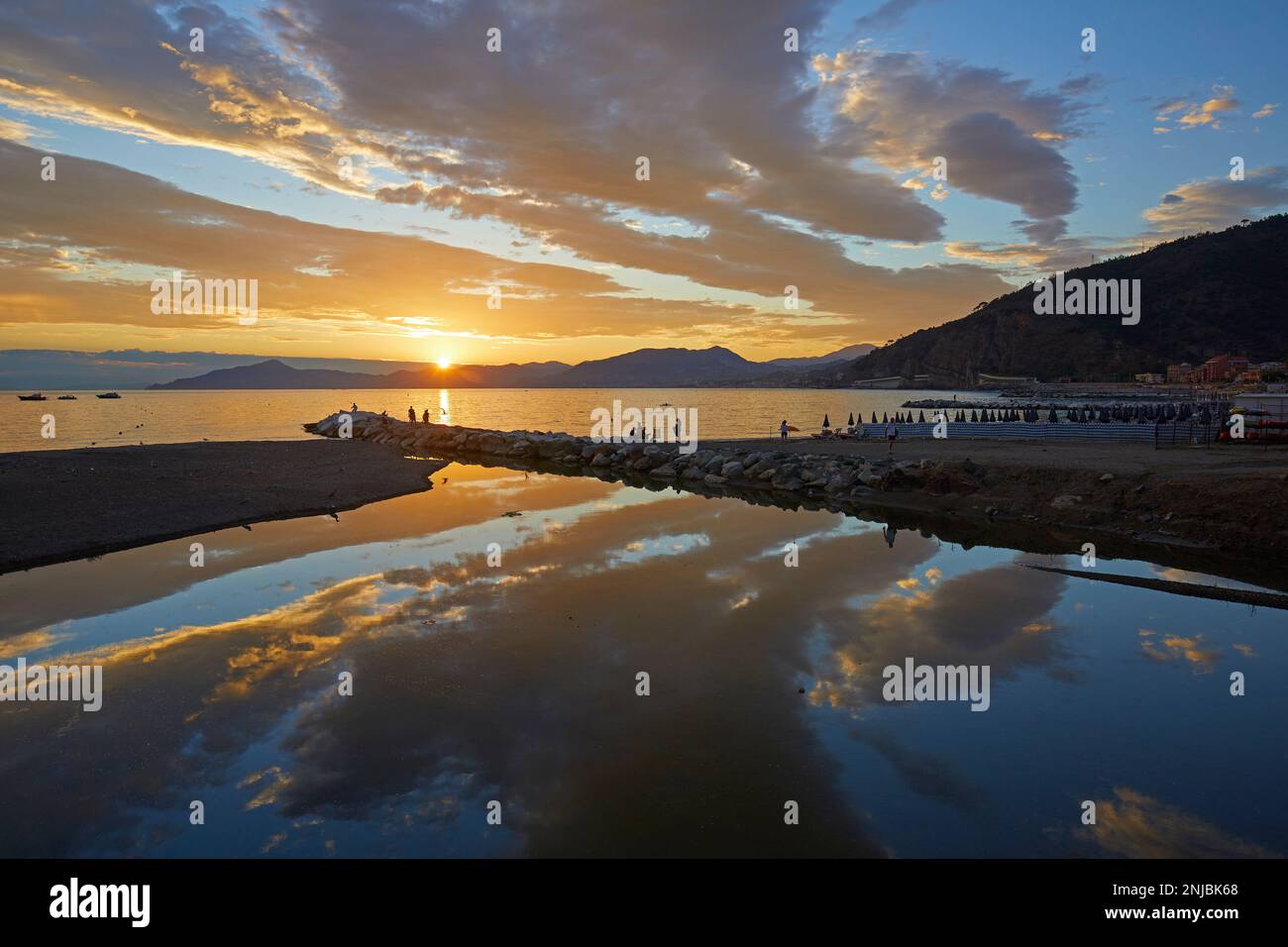 Vibrant sunset reflected in the sea, Sestri Levante, Italy Stock Photo