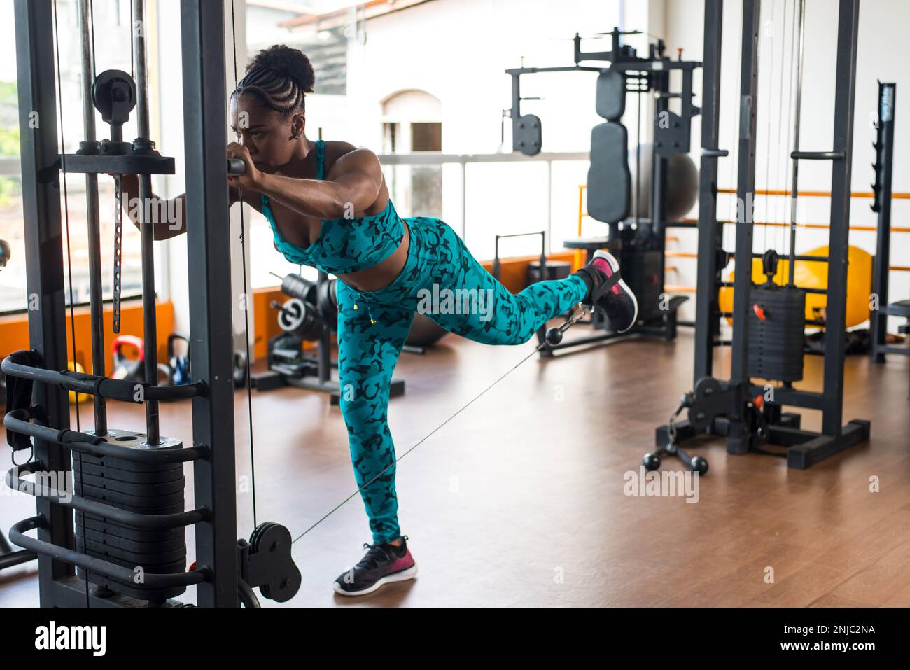 Beautiful woman training leg muscles on the pulley. Bodybuilding exercises Stock Photo Alamy