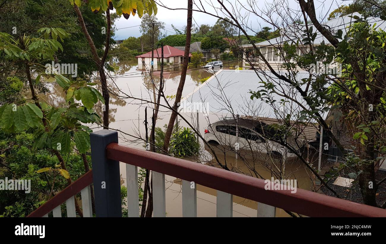 Brisbane, Australia - Feb 28, 2022: View from flooded home. Road, cars, and houses flooded after the heavy rain in Rocklea suburb Stock Photo