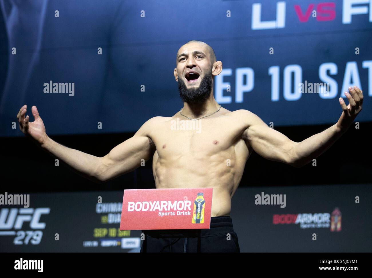 UFC fighter Khamzat Chimaev poses on the scale during a ceremonial weigh-in for the UFC 279 mixed martial arts event Friday, Sept