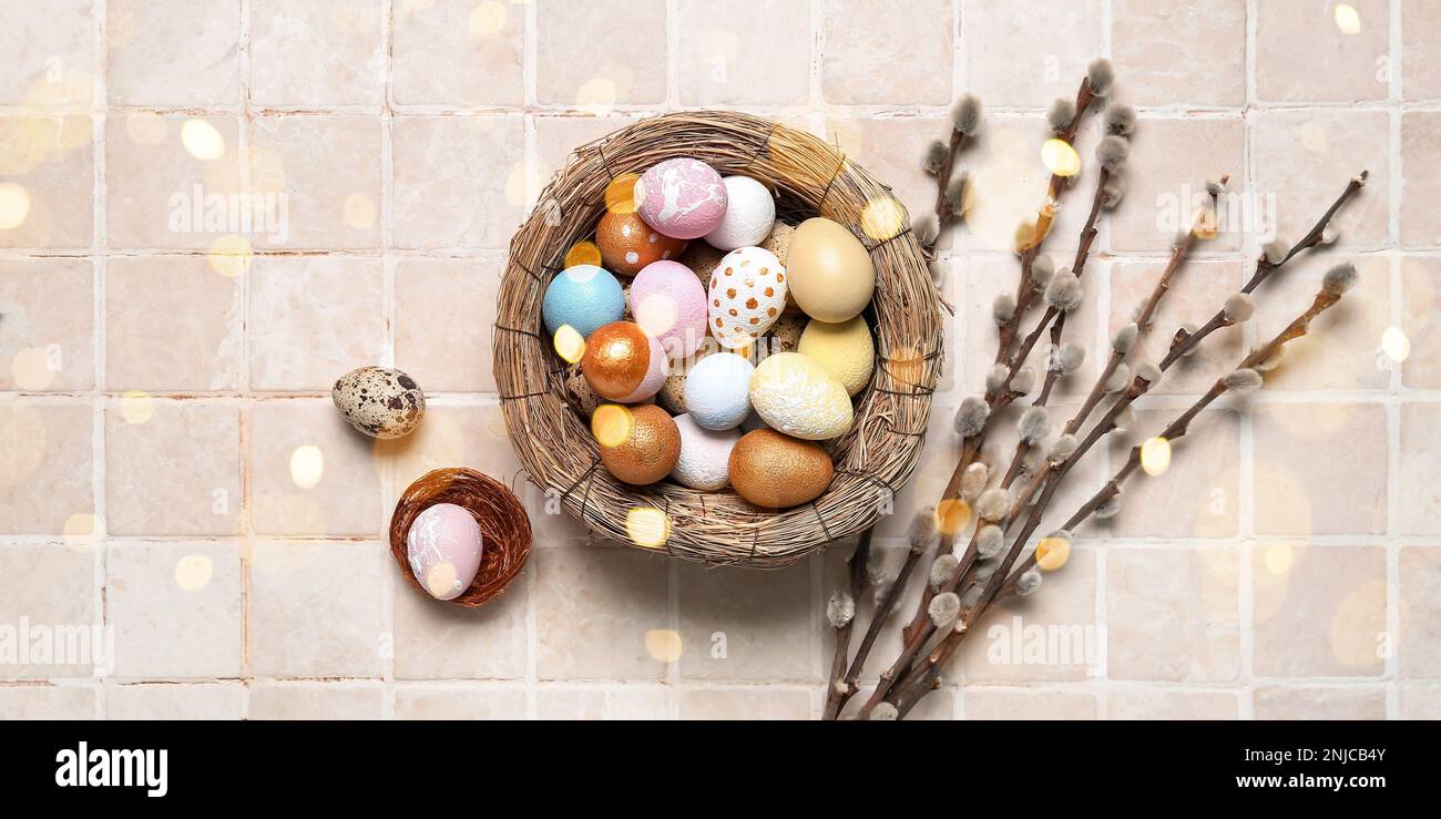 Nest with Easter eggs and pussy willow branches on light background ...