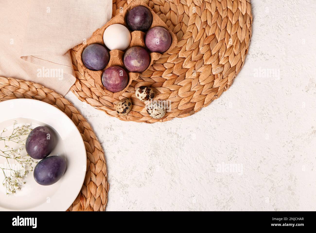 Painted Easter eggs and gypsophila flowers on white grunge background ...