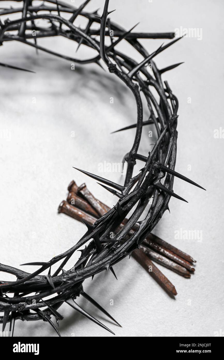Crown of thorns and nails on light background, closeup Stock Photo - Alamy