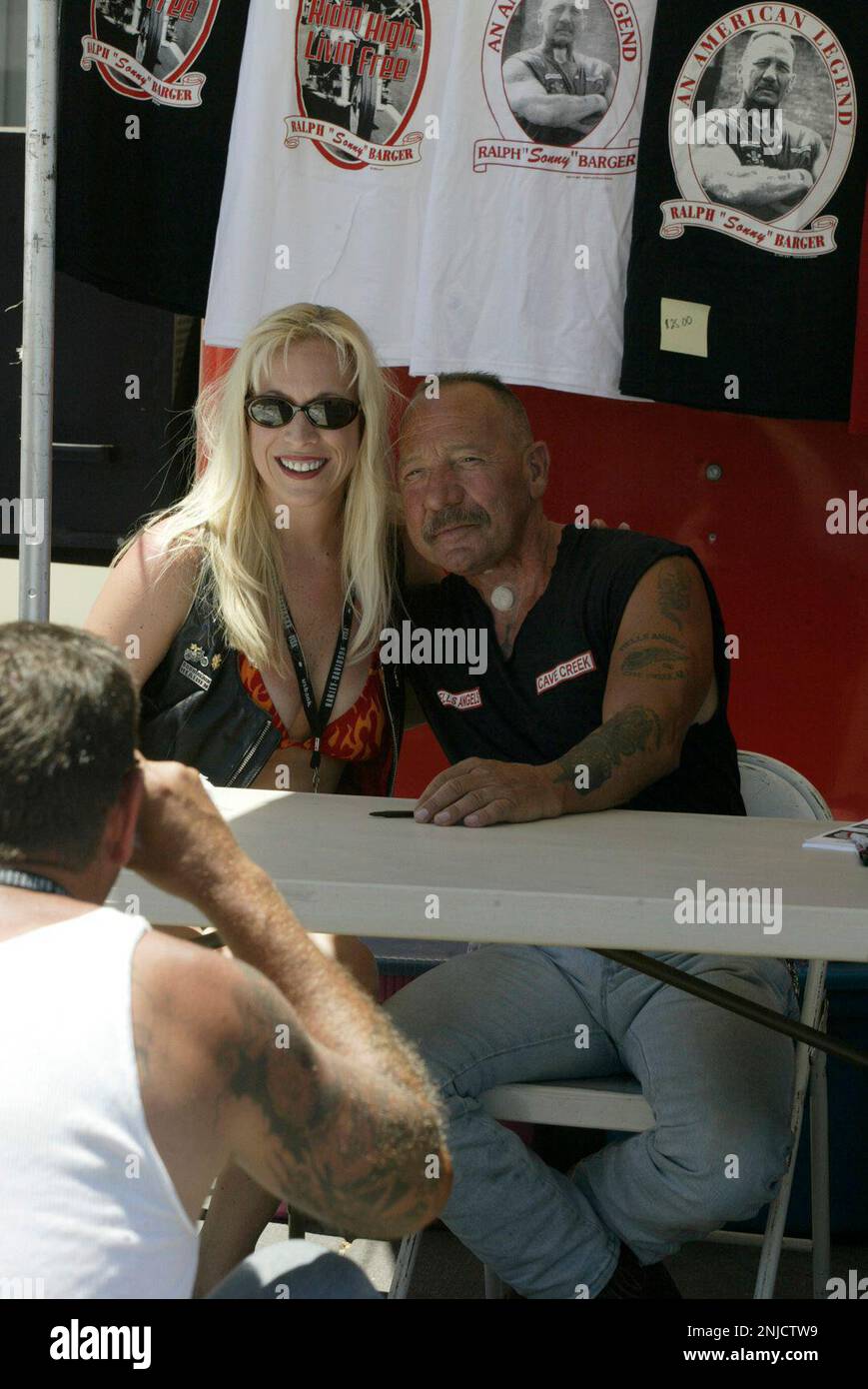 HOLLISTER6-C-05JUL02-PZ-LH--Ralph "Sonny" Barger, founder of the Oakland Chapter of the Hells Angels, taking a picture with Valerie Morrison of San Bernardino during his book signing in the parking lot of Corbin Motors. (PHOTOGRAPHED BY LIZ HAFALIA/THE SAN FRANCISCO CHRONICLE) (LIZ HAFALIA/San Francisco Chronicle via AP) Stock Photo