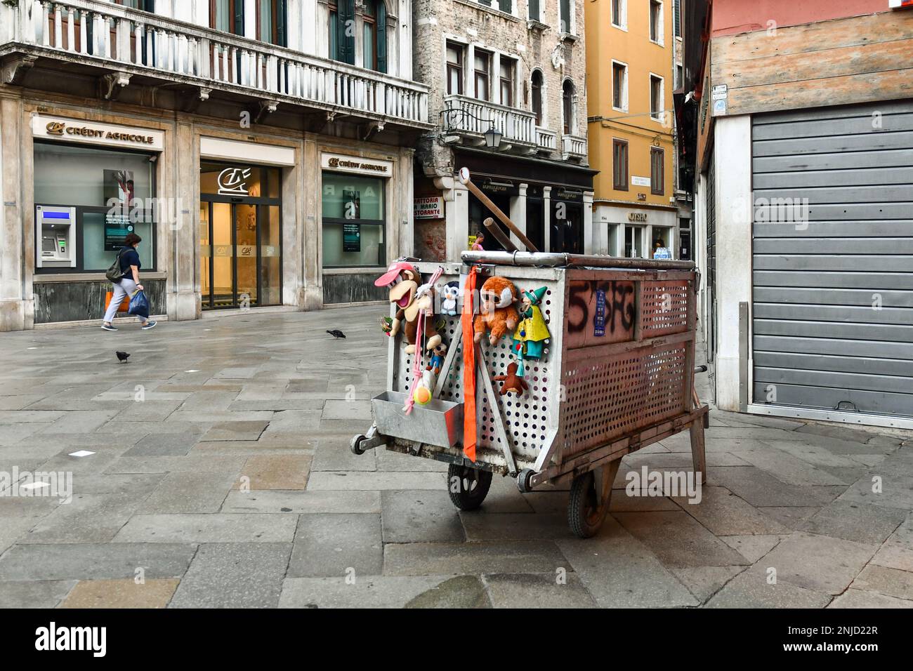 Cleaning cart with lost toys in Campo San Bartolomio, sestiere of San Marco, not crowded early in the morning, Venice, Veneto, Italy Stock Photo