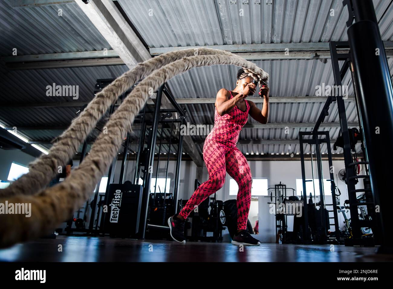 Woman doing training with naval rope. Abdominal strengthening and ...