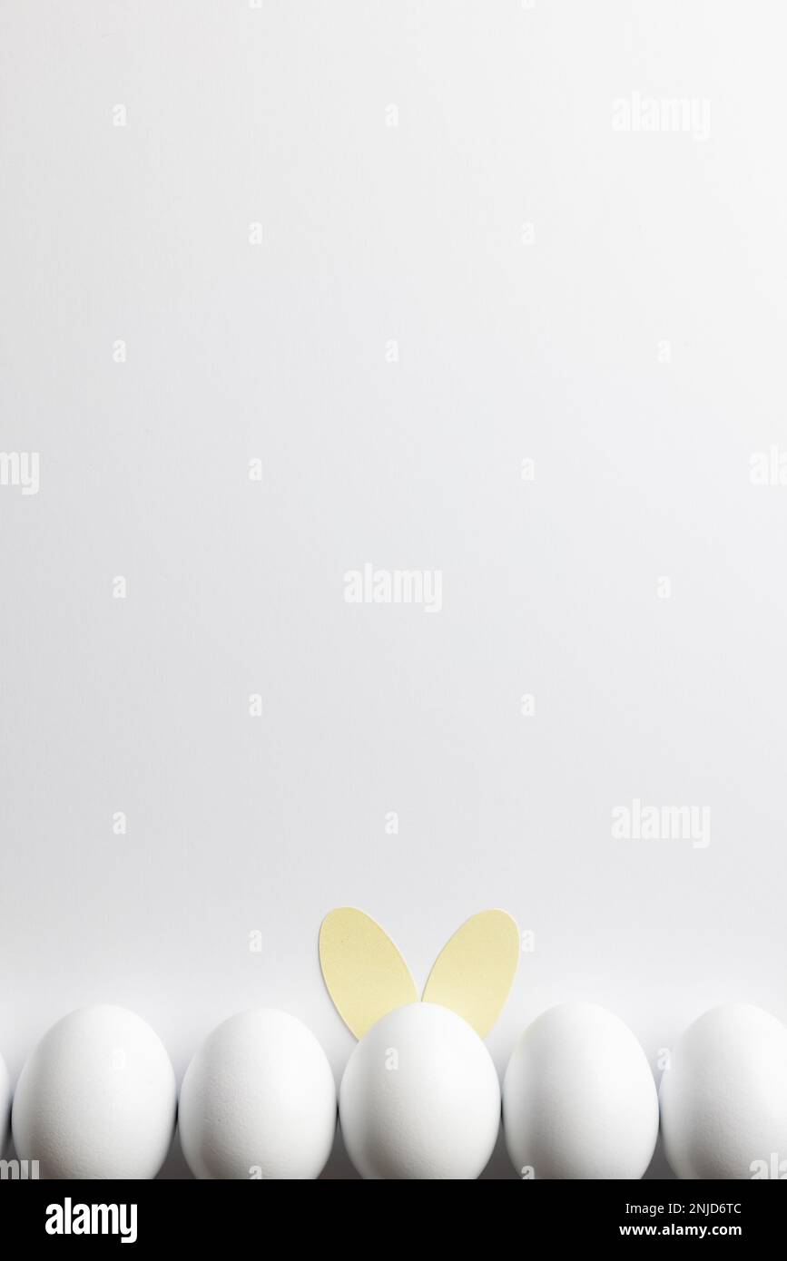 Image of row of white easter eggs with bunny ears and copy space on ...