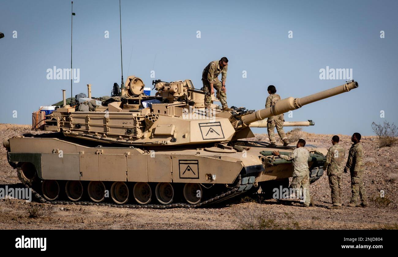 Soldiers assigned to the 2nd Armored Brigade Combat Team, 1st Infantry Division inspect a M1 Abrams Tank at the National Training Center on Fort Irwin, California, August 6, 2022. The Soldiers attended the 22-09 rotation at NTC to test their equipment and mastery of job-specific skills in a combat environment. Stock Photo