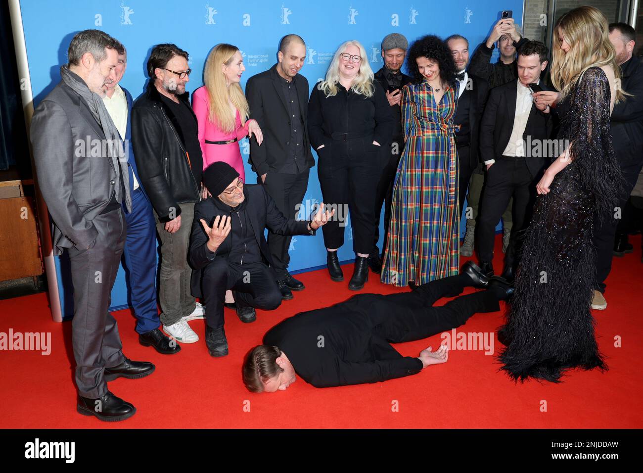 The cast stand around actors Alexander Skarsgard, on the ground, Mia ...
