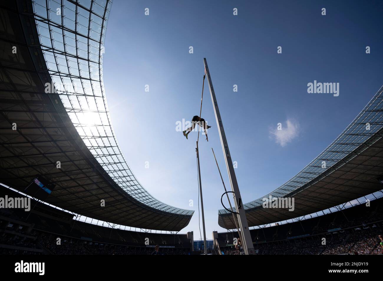 A competitor jumps over the bar during the pole vault competition at