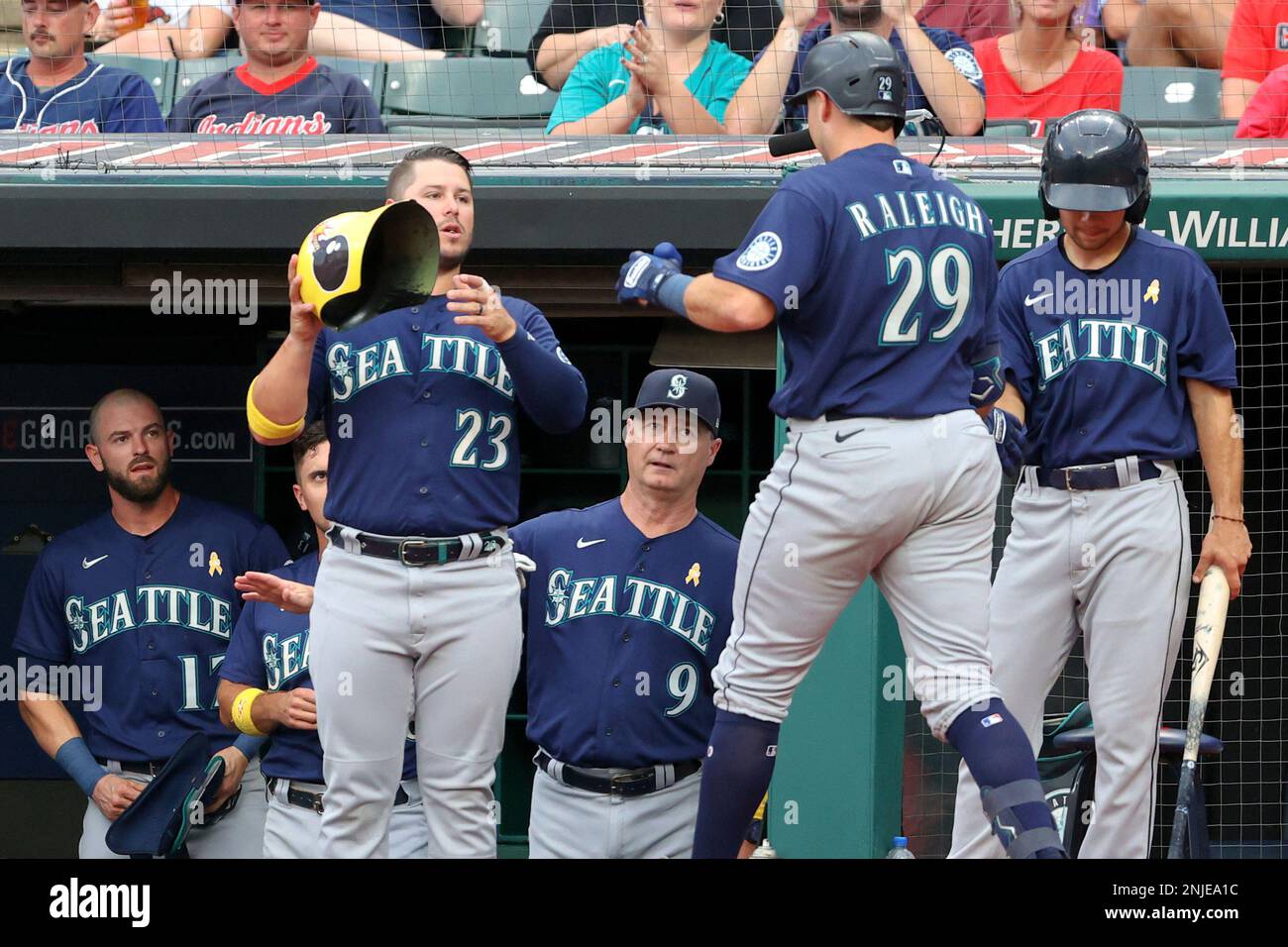 CLEVELAND, OH - SEPTEMBER 02: Seattle Mariners first baseman Ty France (23)  waits to put the home run helmet on Seattle Mariners catcher Cal Raleigh  (29) after Raleigh hit a home run