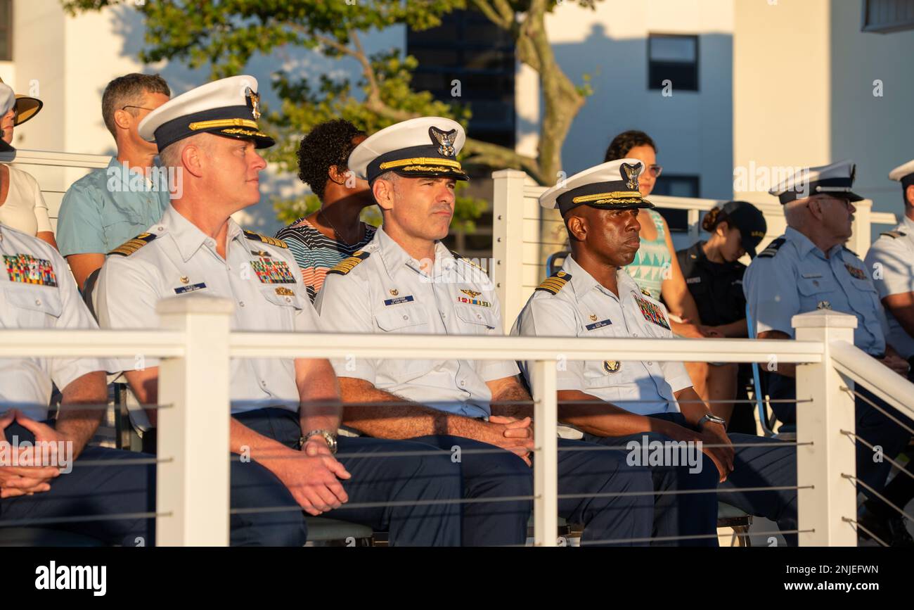 Capt. Warren Judge, commanding officer of U.S. Coast Guard Training Center Cape May, N.J., hosts a Sunset Parade on base to honor the Coast Guard’s 232nd birthday and recognize regional operational commands, Aug. 7, 2022. This year the base highlighted our regional operational commands. In attendance was Capt. Jonathan Theel (left), the Sector Delaware Bay commanding officer, and Capt. Jeffrey Graham (center), the Air Station Atlantic City commanding officer. Stock Photo