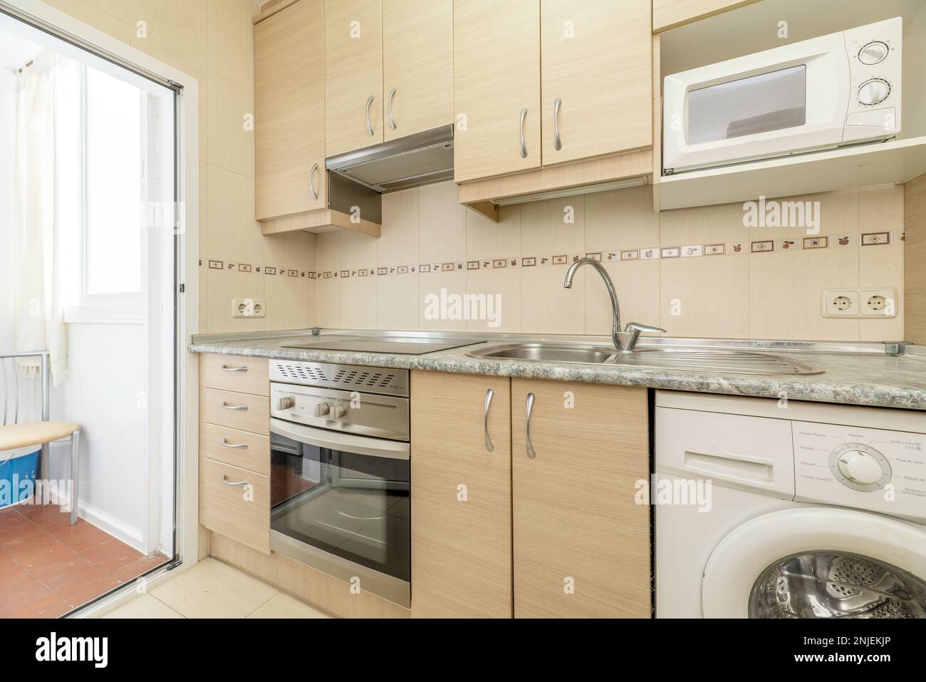 Wall of a kitchen with birch wood furniture with metal handles, integrated  electromesivos of various colors and a drying rack with a white aluminum an  Stock Photo - Alamy, image size:1300x957
