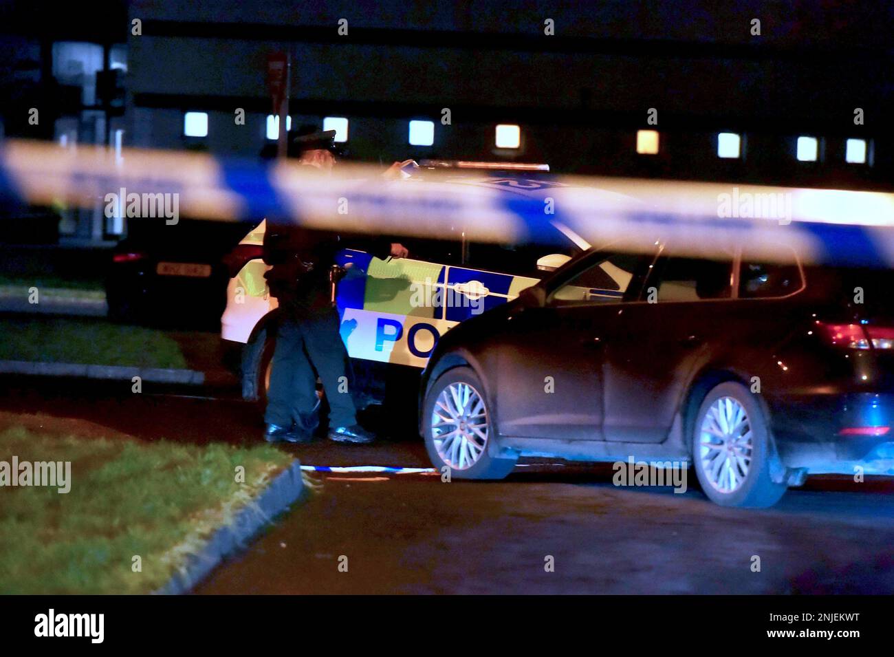 PSNI officers at the scene of a shooting in the Killyclogher Road area