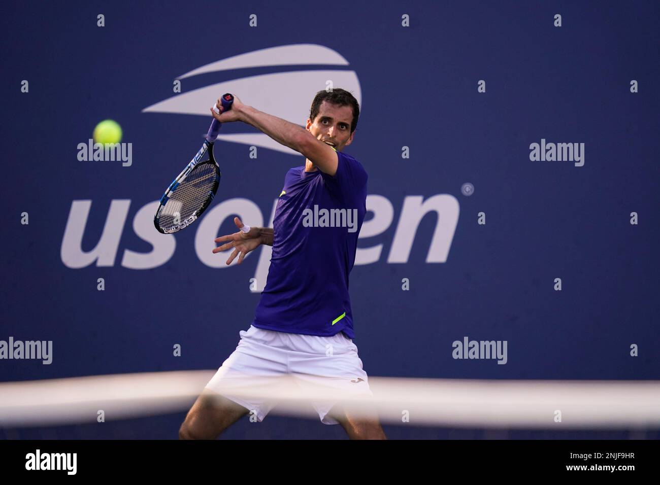 Albert Ramos-Vinolas, of Spain, returns a shot to Norbert Gombos, of Slovakia, during the first round of the US Open tennis championships, Tuesday, Aug